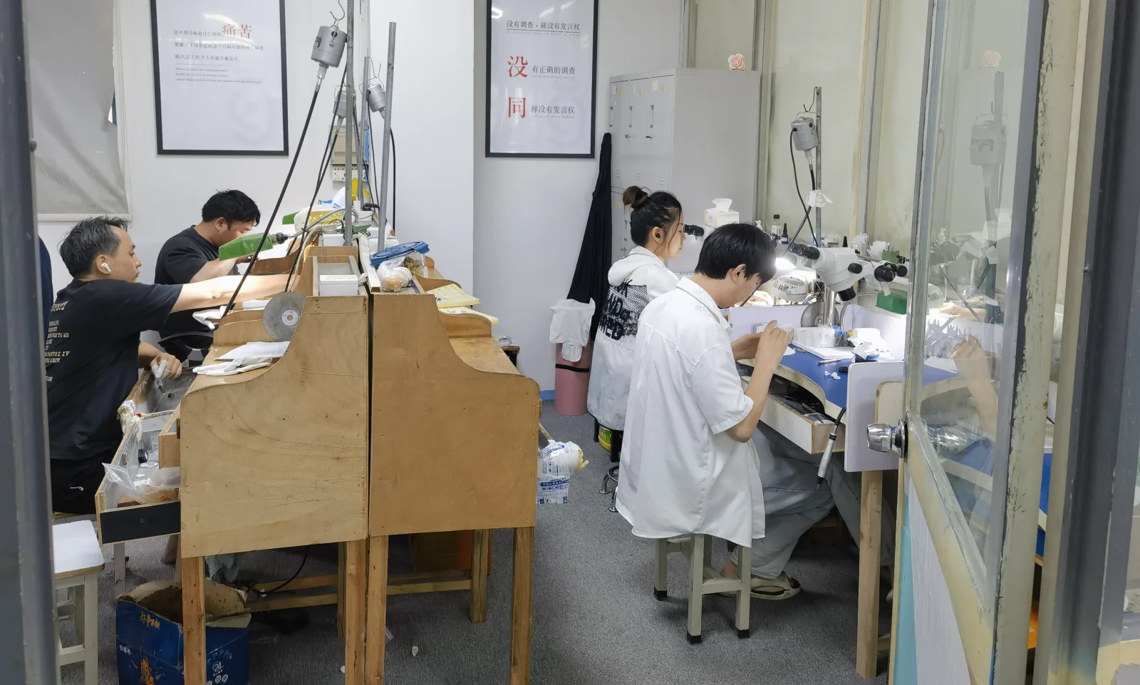 Jewelry artisans setting stones at the Astra Mois moissanite workshop in Panyu, Guangzhou.